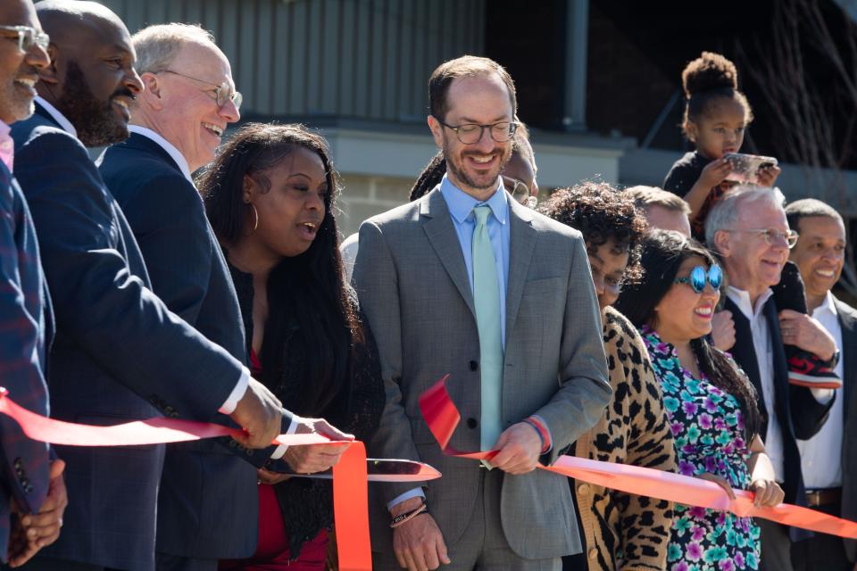 Alexis Jones cuts the red ribbon with Mayor Freddie O'Connell for the opening of the Cherry Oak Apartments in Nashville, Tenn., Thursday, March 28, 2024.