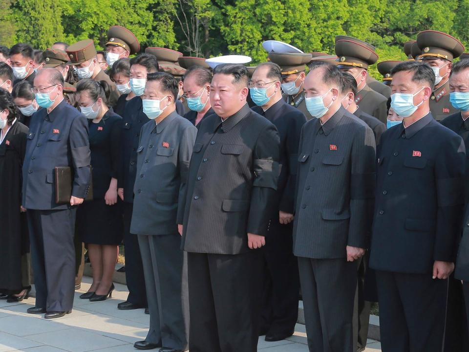 North Korean leader Kim Jong Un (centre) is seen without a mask at a ceremony in Pyongyang on 22 May (Korea News Service via AP)