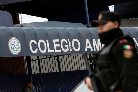 A police officer stands outside the Colegio Americano del Noreste after a student opened fire at the American school in Monterrey, Mexico January 18, 2017. REUTERS/Daniel Becerril