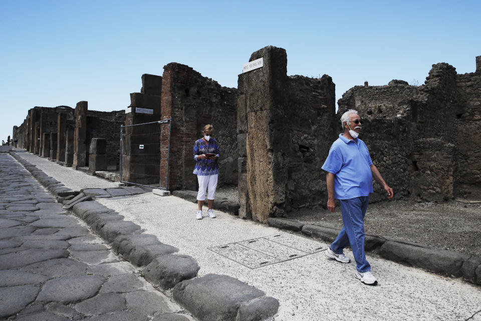 Colleen and Marvin Hewson, from the United States, visit to the archeological site of Pompeii, near Naples, southern Italy, Tuesday, May 26, 2020. The American couple waited a lifetime plus 2 ½ months to visit the ancient ruins of Pompeii together. For Colleen and Marvin Hewson, the visit to the ruins of an ancient city destroyed in A.D. 79 by a volcanic eruption was meant to be the highlight a trip to celebrate his 75th birthday and their 30th anniversary. They were among the only tourists present when the archaeological site reopened to the public on Tuesday after the national lockdown to prevent the spread of COVID-19. (AP Photo/Alessandra Tarantino)