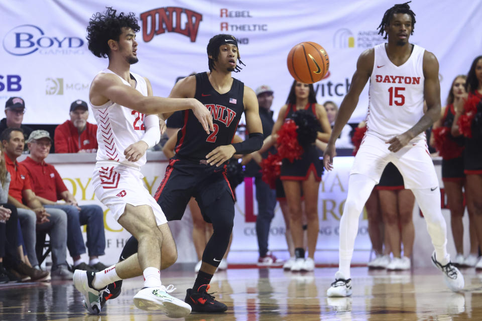 Dayton forward Mustapha Amzil (22) passes the ball in front of UNLV guard Justin Webster (2) during the first half of an NCAA college basketball game Tuesday, Nov. 15, 2022, in Las Vegas. (AP Photo/Chase Stevens)