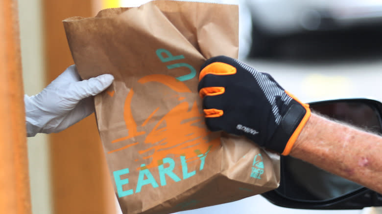 Taco Bell takeout bag exchanges hands