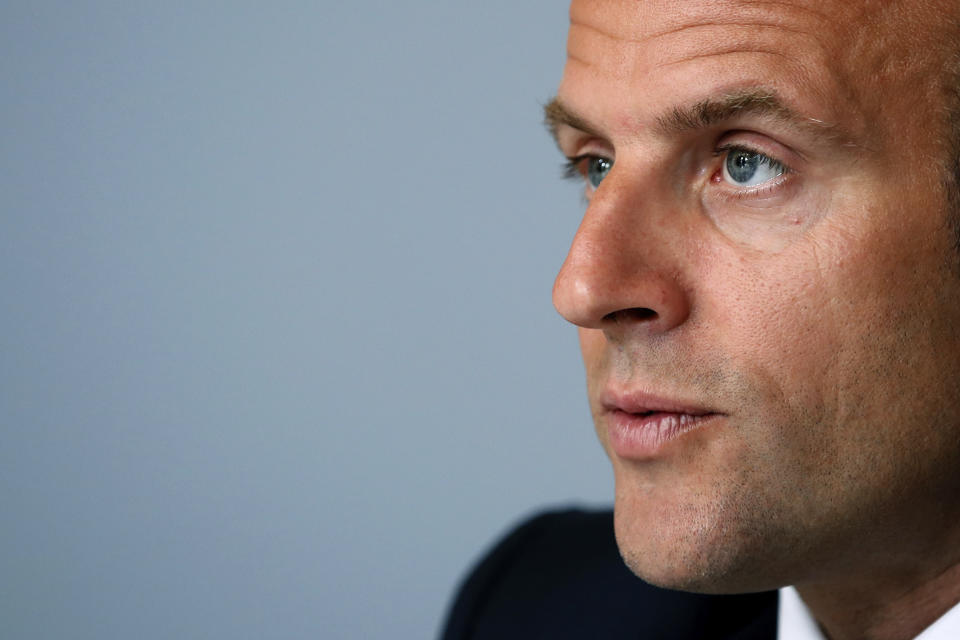 FILE - In this Monday, May 4, 2020 file photo, French President Emmanuel Macron listens during an international video conference call on vaccination, at the Elysee Palace in Paris. Macron is giving an address to his nation Sunday, June 14, 2020 after an unusually long silence, as France faces both exceptional economic blowback from the virus pandemic and rekindled anger over deep-seated racism. In a televised evening address, Macron is expected to focus mainly on the virus that has plunged France into its worst crisis since World War II. (Gonzalo Fuentes/Pool via AP, File)