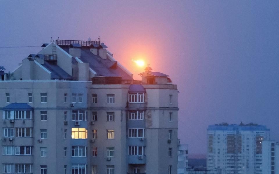 A missile explodes in the sky over Kyiv