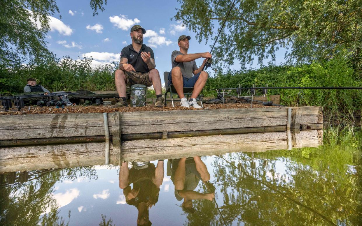 Robbie Arnott (left) a military veteran, says fishing "gives his brain a rest" - Paul Grover for the Telegraph