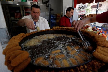 Palestinians sell falafel in Ramallah, in the Israeli-occupied West Bank