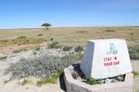 <p>“Stay in your car” is clearly posted on a road marker as one of the rules of the park near the Etosha Pan. (Photo: Gordon Donovan/Yahoo News) </p>