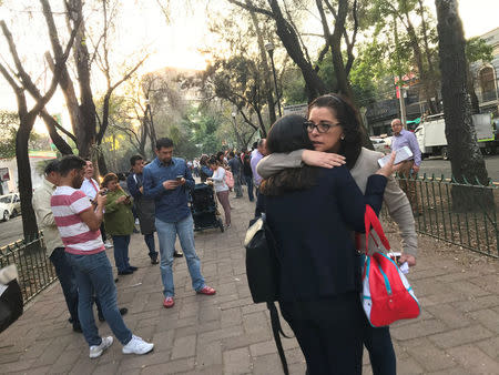 People stand on the street after an earthquake shook buildings in Mexico City, Mexico February 16, 2018. REUTERS/Claudia Daut