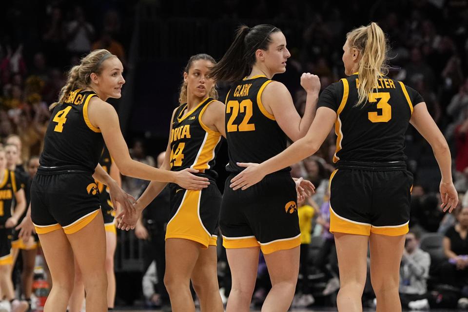 Iowa celebrates after their win against Virginia Tech during an NCAA women's college basketball game Thursday, Nov. 9, 2023, in Charlotte, N.C. (AP Photo/Chris Carlson)