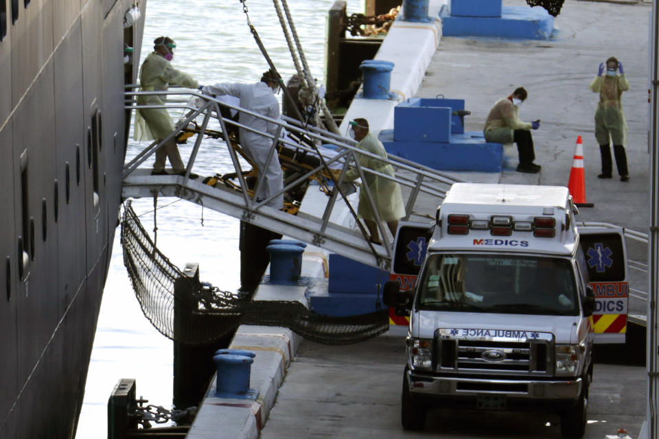 A person on a stretcher is removed from Carnival's Holland America cruise ship Zaandam at Port Everglades during the new coronavirus pandemic, Thursday, April 2, 2020, in Fort Lauderdale, Fla. Those passengers that are fit for travel in accordance with guidelines from the U.S. Centers for Disease Control will be permitted to disembark. (AP Photo/Lynne Sladky)