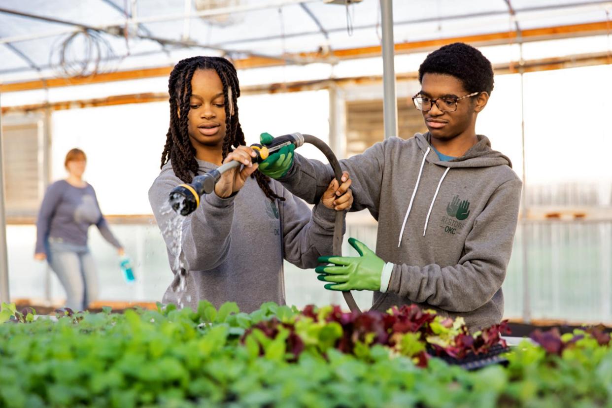 Young interns tend the garden greens at RestoreOKC's Urban Farm at 2222 NE 27th St. in Oklahoma City.
(Credit: RestoreOKC)