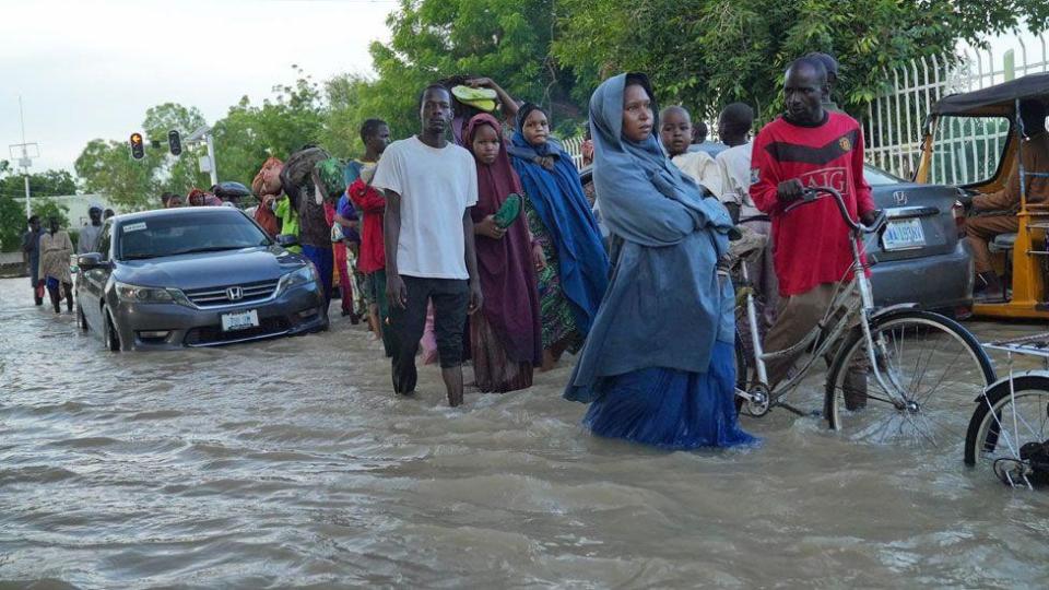 People walking through a flooded street in Maiduguri, Nigeria - September 2024