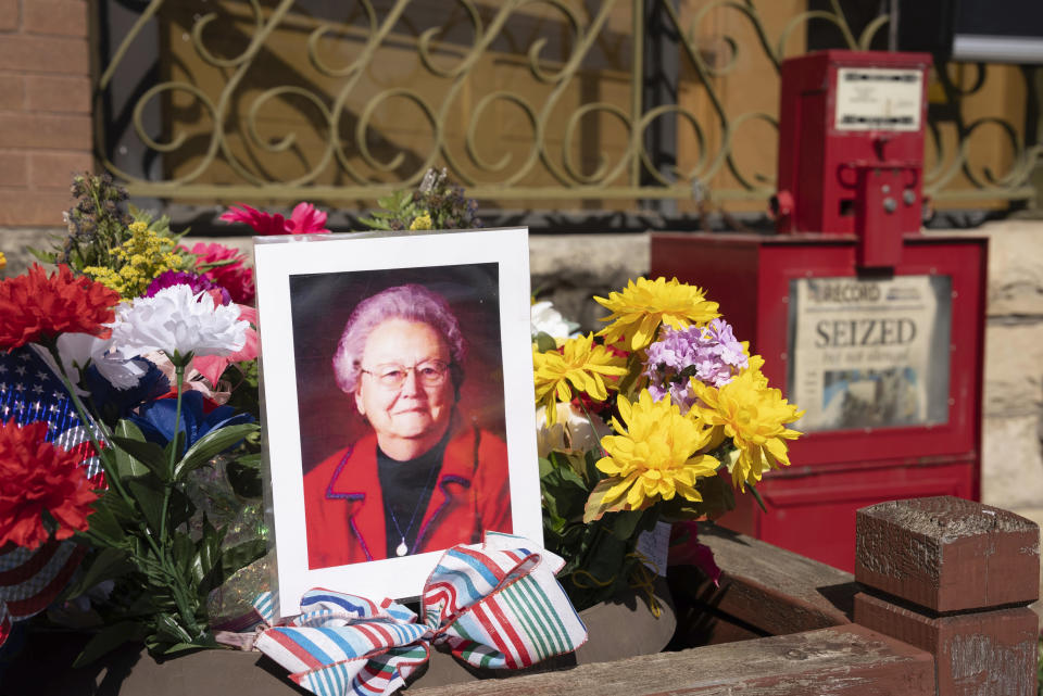 A makeshift shrine is set up in front of the Marion County Record in Marion, Kan. on Saturday, Aug. 19, 2023 with a picture of the newspaper's co-owner Joan Meyer and flowers. (Jaime Green /The Wichita Eagle via AP)