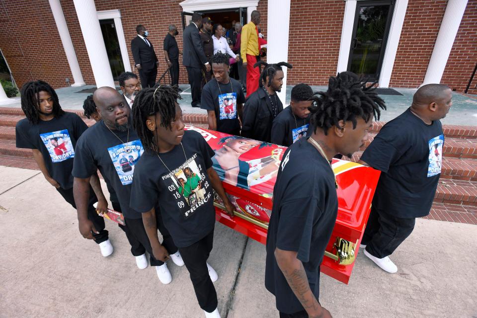 The body of 13-year-old Princeabzavien "Prince" Holland is carried by pallbearers including his siblings to a waiting hearse after his funeral service Saturday at Zion Hope Missionary Baptist Church.  Prince was buried at Evergreen Cemetery.