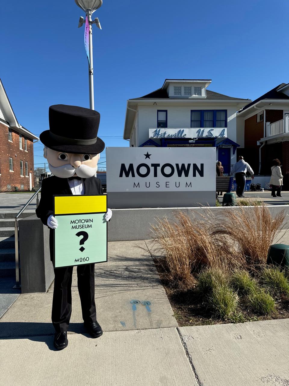 A picture of the Monopoly board game mascot Milburn Pennybags posing in front of Detroit's Motown Museum as Hasbro plans its Detroit Edition Monopoly.