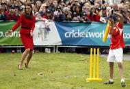 Catherine (L), the Duchess of Cambridge, tries to catch a ball hit by a young boy as she and her husband, Britain's Prince William, attend a promotional event for the upcoming Cricket World Cup in Christchurch April 14, 2014. The Prince and his wife Kate are undertaking a 19-day official visit to New Zealand and Australia with their son George. REUTERS/Phil Noble (NEW ZEALAND - Tags: ROYALS ENTERTAINMENT POLITICS)