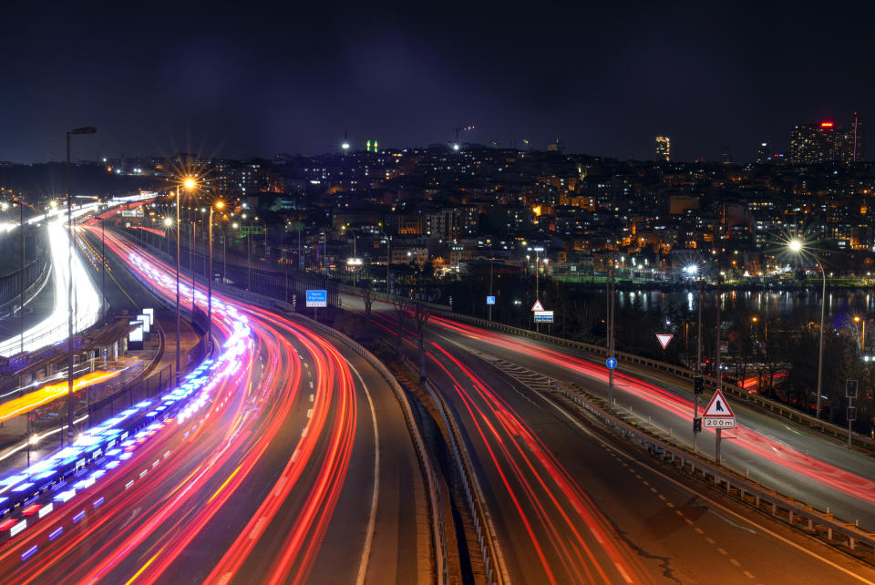 A slow camera shutter blurs the lights of passing commuter cars, in Istanbul, Turkey, Wednesday, March 20, 2024. (AP Photo/Khalil Hamra)