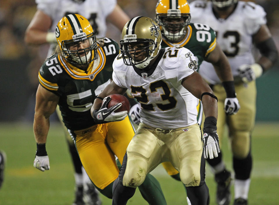 GREEN BAY, WI - SEPTEMBER 08: Pierre Thomas #23 of the New Orleans Saints runs for yardage pursued by Clay Matthews #52 of the Green Bay Packers during the NFL opening season game at Lambeau Field on September 8, 2011 in Green Bay, Wisconsin. (Photo by Jonathan Daniel/Getty Images)