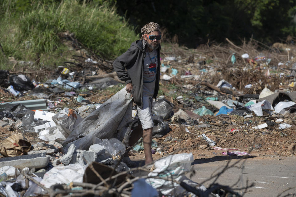 A man collects trash to recycle in the Jardim Julieta squatter camp in Sao Paulo, Brazil, Thursday, July 23, 2020. The coronavirus had just hit the city when this parking lot for trucks became a favela, with dozens of shacks. Since the first wave of residents in mid-March, hundreds of families joined, with most having been evicted during the pandemic. (AP Photo/Andre Penner)