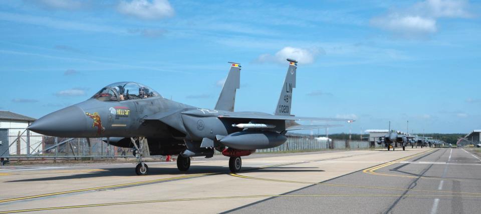 494th Fighter Squadron F-15E Strike Eagles seen returning to RAF Lakenheath on May 8, 2024. The jet in front has a number of red missile silhouettes painted above its name, "Hellcat," that look to reflect air-to-air kills during its recently concluded deployment to the Middle East. <em>USAF</em>