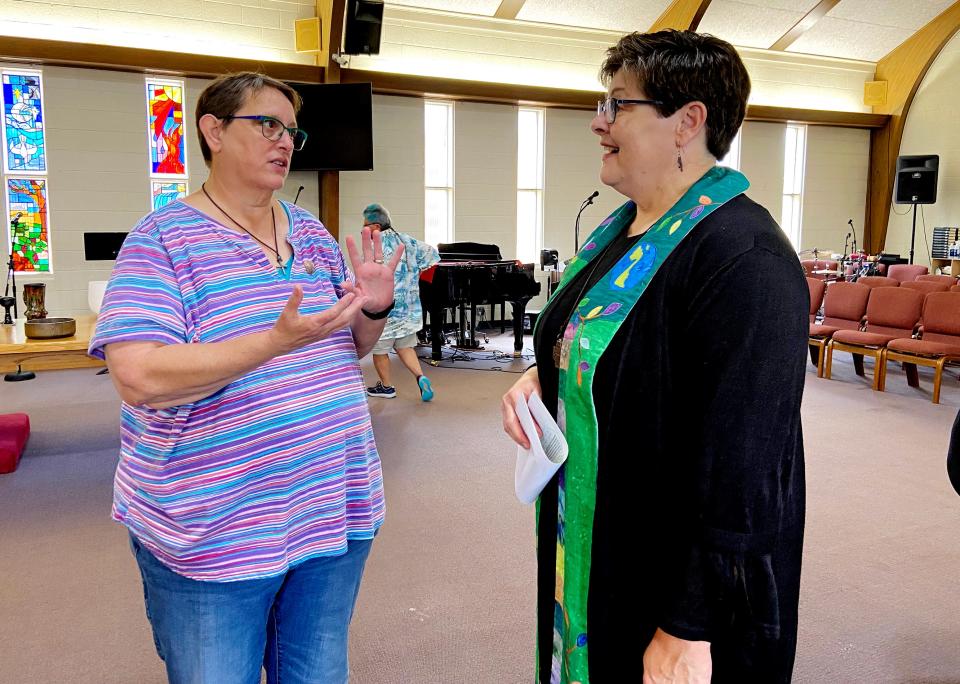 Pam Schoenauer talks with the Rev. Kathy McCallie after a worship service on May 21 at Church of the Open Arms, the church McCallie founded after leaving the United Methodist Church in 1997. 