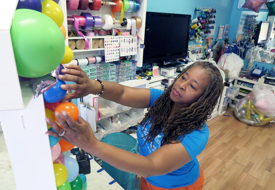 Celebration Creations owner Stephanie Cofield-Mixon arranges balloons inside a large number one for a birthday at the Stafford Township business Monday, May 20, 2024.