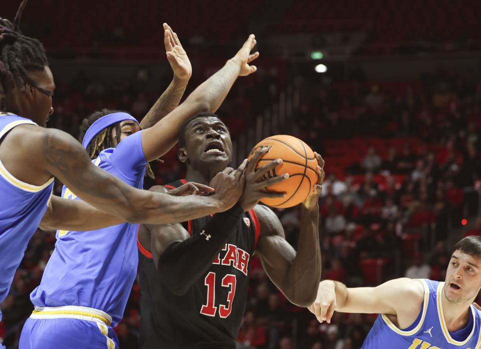 Utah Utes center Keba Keita (13) drives to the basket through UCLA’s UCLA Bruins’ Kenneth Nwuba, Devin Williams and Lazar Stefanovic at the University of Utah’s Huntsman Center in Salt Lake City on Thursday, Jan. 11, 2024. | Laura Seitz, Deseret News