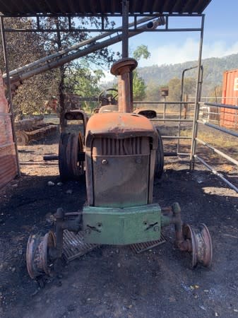 A tractor destroyed by the Sand Fire is seen at a farm in the Capay Valley in California