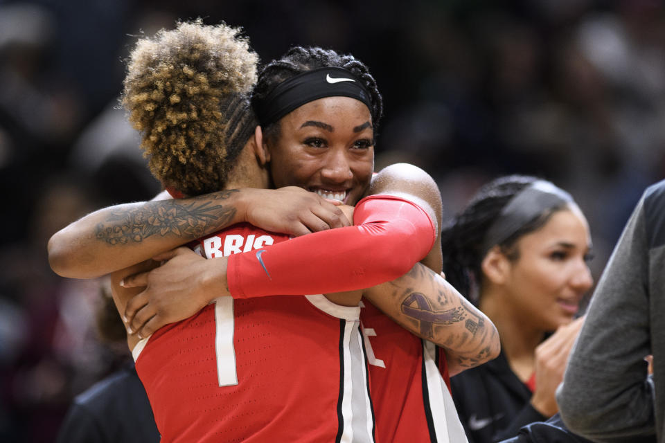Ohio State forward Cotie McMahon, right, and guard Rikki Harris (1) embrace after a victory against UConn in a Sweet 16 college basketball game of the NCAA Tournament in Seattle, Saturday, March 25, 2023. (AP Photo/Caean Couto)