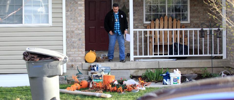 Pleasant Grove Police investigate the scene where seven infant bodies were discovered and packaged in separate containers at a home in Pleasant Grove, Utah, Sunday, April 13, 2014. (AP Photo/Rick Bowmer)