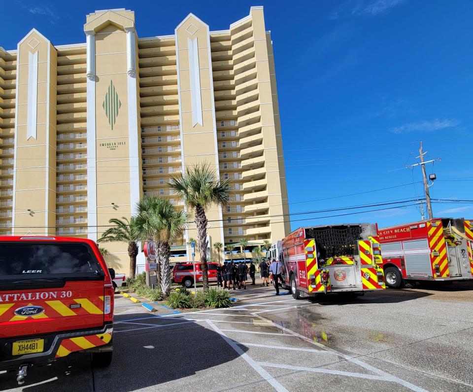 Panama City Beach firefighters gather across from the Emerald Isle Beach Resort as they prepare to pump water into the building's system. The building's fire pump is down and the added water will keep the internal supply topped off in the event of a fire, according to Battalion Chief Tim Smith.