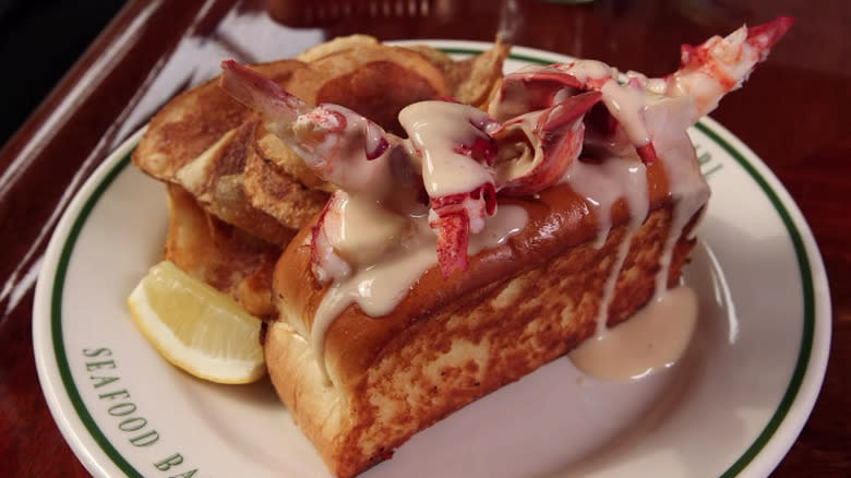 Lobster roll on a plate with potato chips
