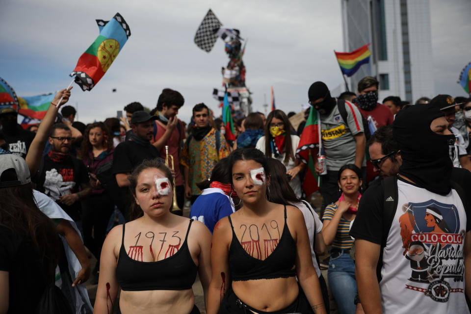 Women dressed in black perform to mourn those who have been killed, tortured and raped, during an anti-government protest in Santiago, Chile, Friday, Nov. 1, 2019. Chile has been facing days of unrest, triggered by a relatively minor increase in subway fares. The protests have shaken a nation noted for economic stability over the past decades, which has seen steadily declining poverty despite persistent high rates of inequality. (AP Photo/Rodrigo Abd)