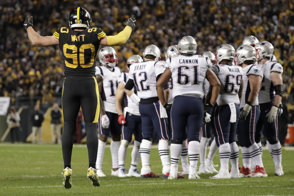 Pittsburgh Steelers outside linebacker T.J. Watt (90) calls the crowd to action as New England Patriots quarterback Tom Brady (12) huddles his team during the second half of an NFL football game in Pittsburgh, Sunday, Dec. 16, 2018. The Steelers won 17-10. (AP Photo/Don Wright)