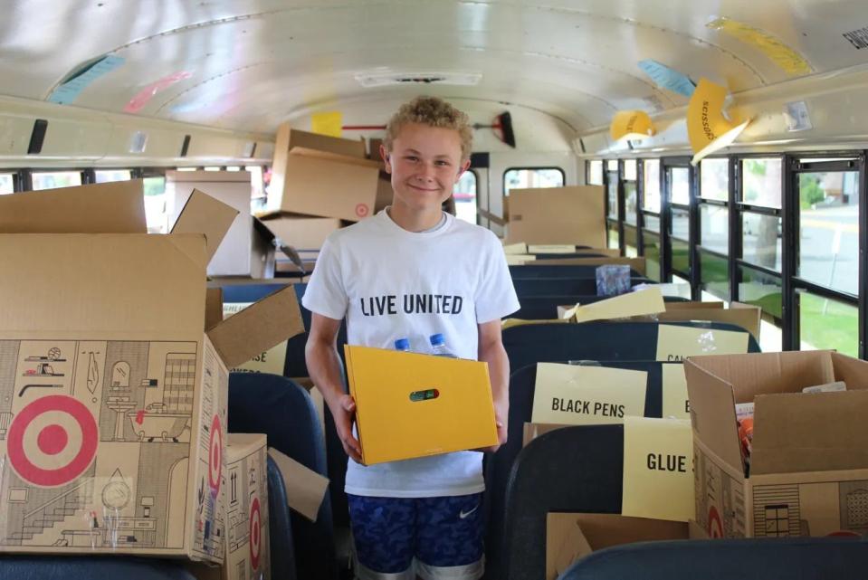 Tyler Holland volunteers for Stuff the Bus in 2022. Items collected at this year’s event will be given to local kids through nonprofits, the school district and the Back 2 School Blast on Aug. 18.