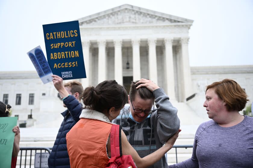 Jessica Golibart (C) cries as demonstrators gather in front of the US Supreme Court in Washington, DC, on May 3, 2022. - The Supreme Court is poised to strike down the right to abortion in the US, according to a leaked draft of a majority opinion that would shred nearly 50 years of constitutional protections. The draft, obtained by Politico, was written by Justice Samuel Alito, and has been circulated inside the conservative-dominated court, the news outlet reported. Politico stressed that the document it obtained is a draft and opinions could change. The court is expected to issue a decision by June. The draft opinion calls the landmark 1973 Roe v Wade decision "egregiously wrong from the start." (Photo by Brendan SMIALOWSKI / AFP) (Photo by BRENDAN SMIALOWSKI/AFP via Getty Images)