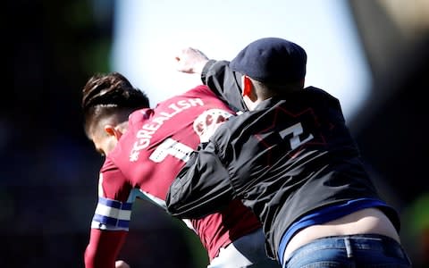 A fan invades the pitch and attacks Aston Villa's Jack Grealish during the match - Credit: Action Images via Reuters/Carl Recine