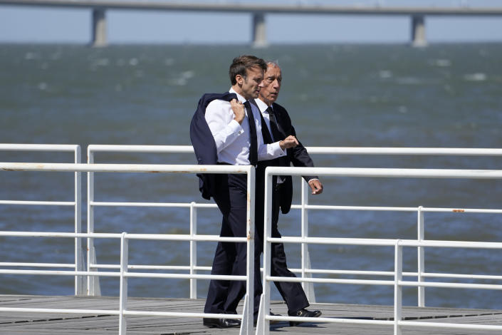 French President Emmanuel Macron takes a walk with his Portuguese counterpart Marcelo Rebelo de Sousa on a walkway outside the venue hosting the United Nations Ocean Conference in Lisbon, Thursday, June 30, 2022. From June 27 to July 1, the United Nations is holding its Oceans Conference in Lisbon expecting to bring fresh momentum for efforts to find an international agreement on protecting the world's oceans. (AP Photo/Armando Franca)