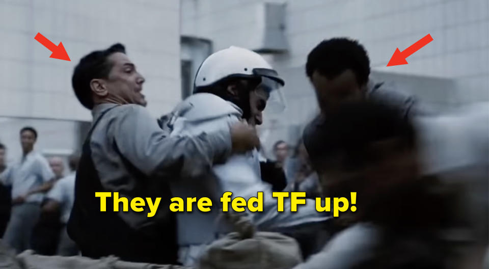 Two protestors fighting against a guard with the caption "They are fed TF up!"