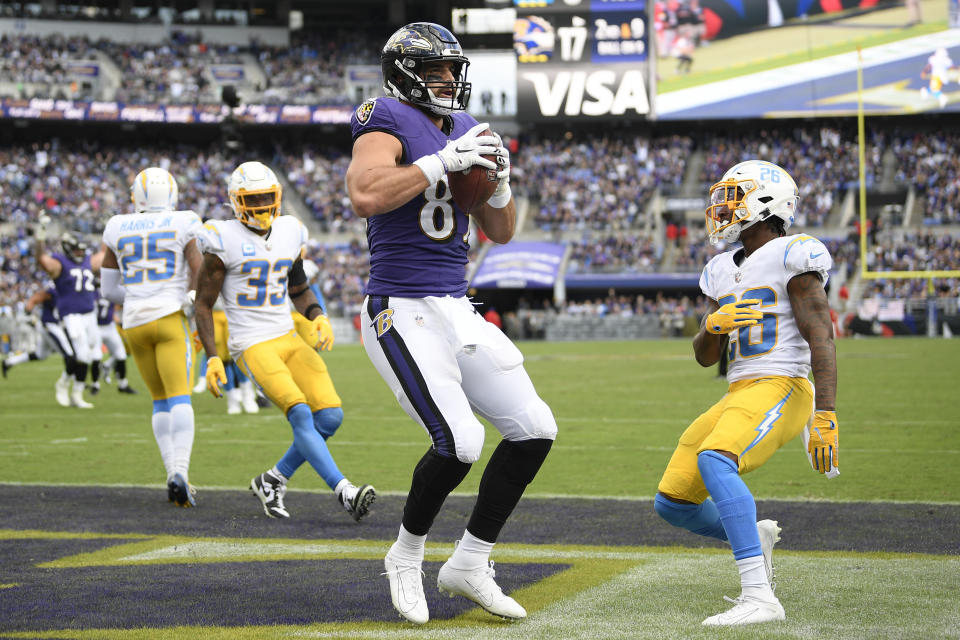 Baltimore Ravens tight end Mark Andrews, center, looks on after catching a touchdown pass from quarterback Lamar Jackson, not visible, during the second half of an NFL football game against the Los Angeles Chargers, Sunday, Oct. 17, 2021, in Baltimore. (AP Photo/Nick Wass)