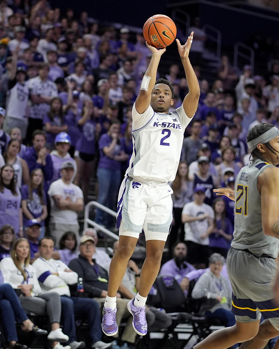 Kansas State guard Tylor Perry puts up a three-point-shot during the second half of an NCAA college basketball game against West Virginia Monday, Feb. 26, 2024, in Manhattan, Kan. (AP Photo/Charlie Riedel)