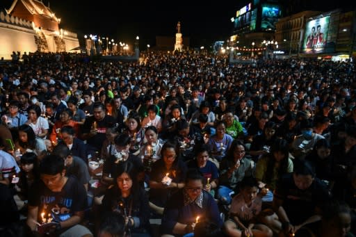 People gather for a candlelight vigil in Nakhon Ratchasima, Thailand, following a mass shooting which Prime Minister Prayut Chan-O-Cha called unprecedented