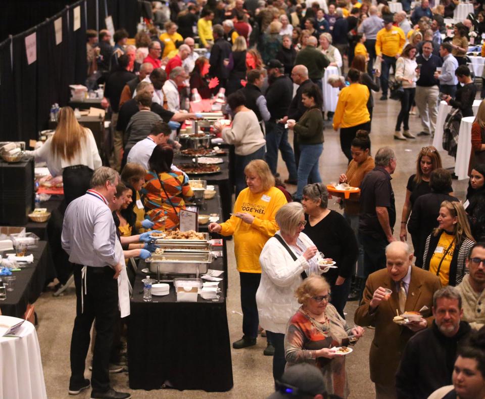People pack the floor for Celebrity Cuisine at the Canton Memorial Civic Center on Tuesday.  Hosted by Atlantic Food Distributors and the Tri-County Restaurant Association, the event benefited Community Harvest, a hunger-relief program of Akron-Canton Regional Foodbank.