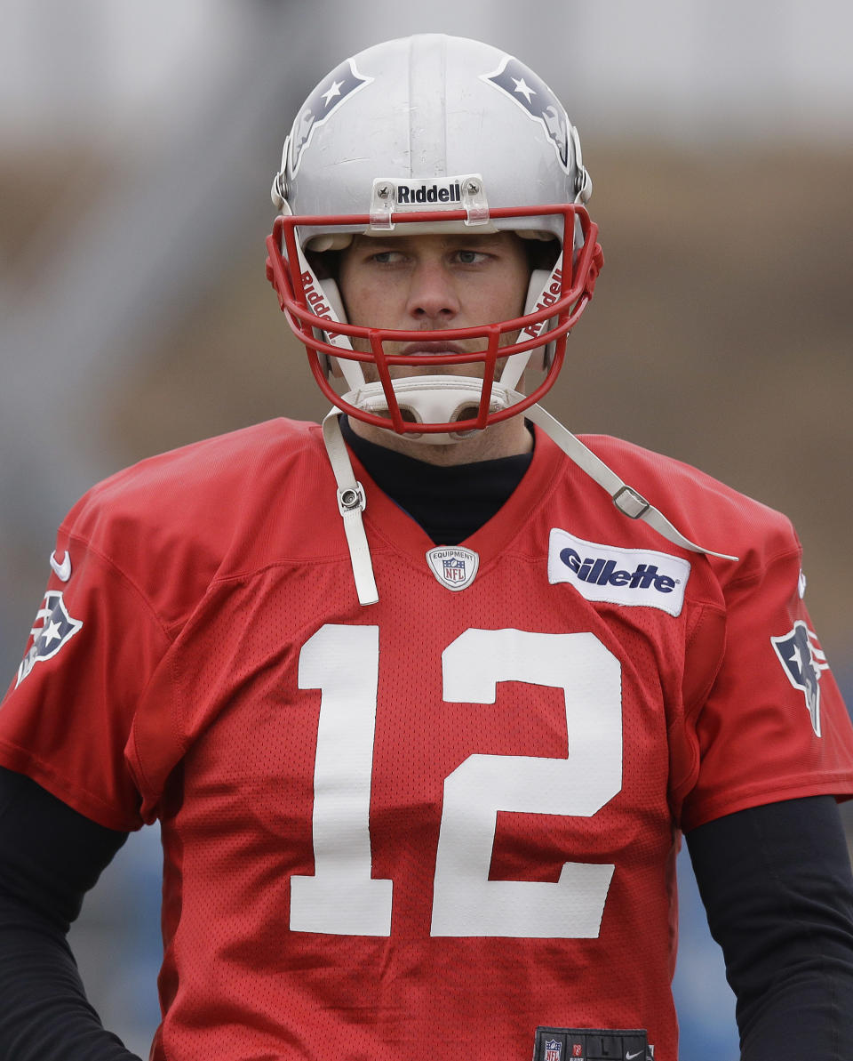 New England Patriots quarterback Tom Brady (12) walks across the field during a drills and stretching session before practice begins at the NFL football team's facility in Foxborough, Mass., Thursday, Jan. 16, 2014. The Patriots will play the Denver Broncos in the AFC Championship game Sunday in Denver. (AP Photo/Stephan Savoia)