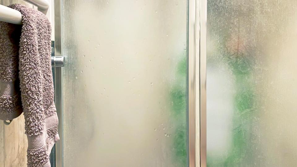 A cloudy shower door that can be cleaned with powerwash