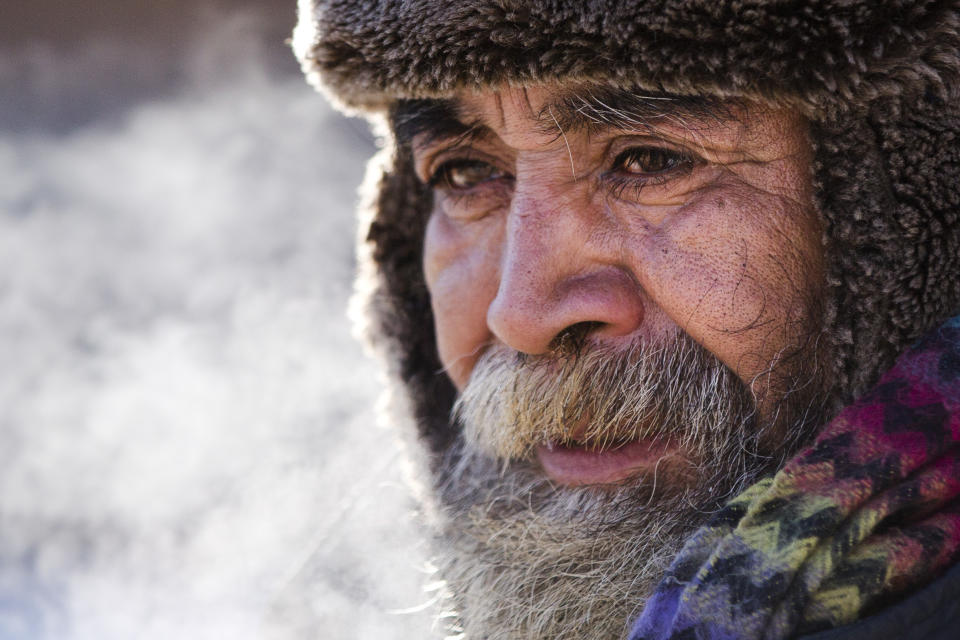 Ramon Perez of Mexico who is homeless, comes in out of the cold after speaking with Project H.O.M.E. Outreach Response Worker Sam Santiago, (not seen), Tuesday, Jan. 7, 2014, in Philadelphia. With low temperatures hovering around zero and wind chills in the minus-teens a code blue alert for severe weather has been issued by the city to encouraged and sometimes compel the homeless to seek shelter. (AP Photo/Matt Rourke)