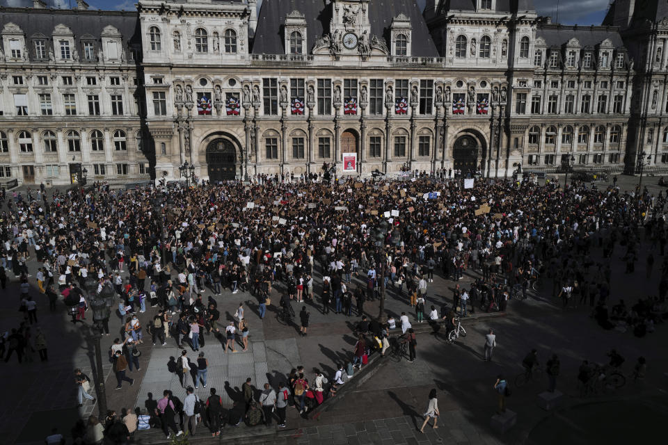 Women's rights activists protest against French President Emmanuel Macron's appointment of an interior minister who has been accused of rape and a justice minister who has criticized the #MeToo movement, in front of Paris city hall, in Paris, France, Friday, July 10, 2020. The French government said it remains committed to gender equality and defended the new ministers, stressing the presumption of innocence. Gerald Darmanin, Interior Minister, firmly denies the rape accusation, and an investigation is underway. New Justice Minister Eric Dupond-Moretti is a lawyer who has defended a government member accused of rape and sexual assault, and has ridiculed women speaking out thanks to the #MeToo movement. (AP Photo/Francois Mori)