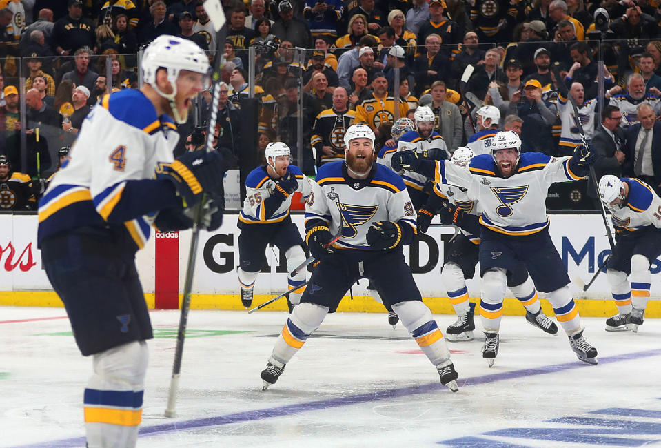 BOSTON, MA - MAY 29:  Blues Carl Gunnarsson (left) celebrates after scoring the game winning overtime goal as his teammates rush on to the ice to congratulate him. The Boston Bruins host the St. Louis Blues in Game 2 of the 2019 Stanley Cup Finals at TD Garden on May 29, 2019. (Photo by John Tlumacki/The Boston Globe via Getty Images)