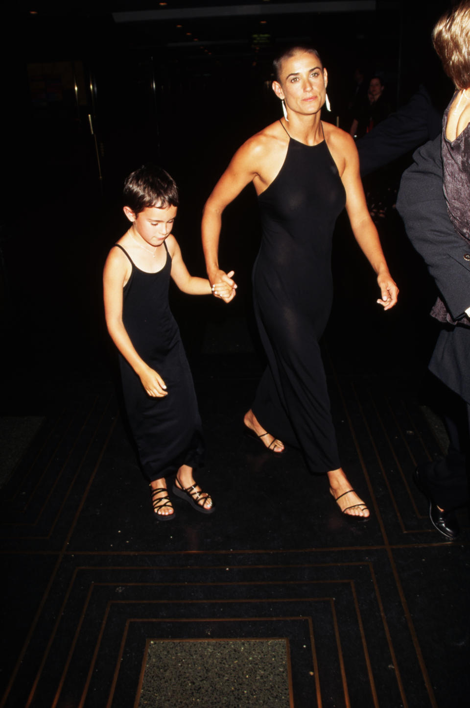 Her head still shaved from her role in G.I. Jane, Demi Moore attends the premiere of Striptease with her daughter Rumer Willis.   (Photo by Mitchell Gerber/Corbis/VCG via Getty Images)