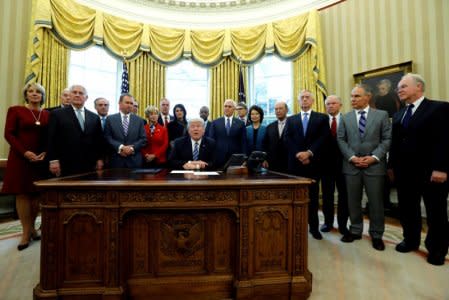 U.S. President Donald Trump is surrounded by his cabinet, including Education Secretary Betsy DeVos (L-R), Secretary of Homeland Security John Kelly, Secretary of State Rex Tillerson, Secretary of Veterans Affairs David Shulkin, Office of Management and Budget (OMB) Director Mick Mulvaney, Treasury Secretary Steven Mnuchin, Small Business Administration (SBA) Administrator Linda McMahon, Interior Secretary Ryan Zinke, U.S. Ambassador to the United Nations Nikki Haley, Secretary of Housing and Urban Development (HUD) Ben Carson, Vice President Mike Pence, Energy Secretary Rick Perry, Transportation Secretary Elaine Chao, Commerce Secretary Wilbur Ross, Defense Secretary James Mattis, Attorney General Jeff Sessions, Attorney General Jeff Sessions, Environmental Protection Agency (EPA) Administrator Scott Pruitt and Secretary of Health and Human Services (HHS) Tom Price, as he signs an executive order entitled